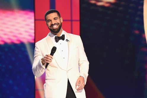 Drake wearing a white blazer and shirt with a black bow tie, and black pants at the 2019 Billboard M...