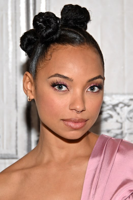 Logan Browning posing with stacked buns hairstyle