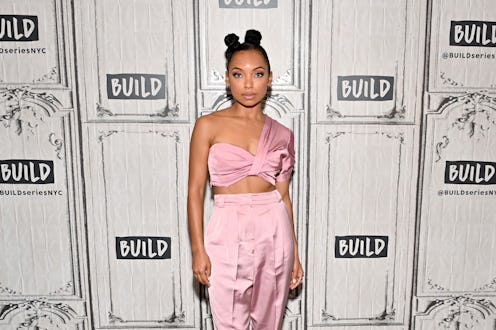 Logan Browning posing with her natural hairstyle with two buns