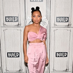 Logan Browning posing with her natural hairstyle with two buns