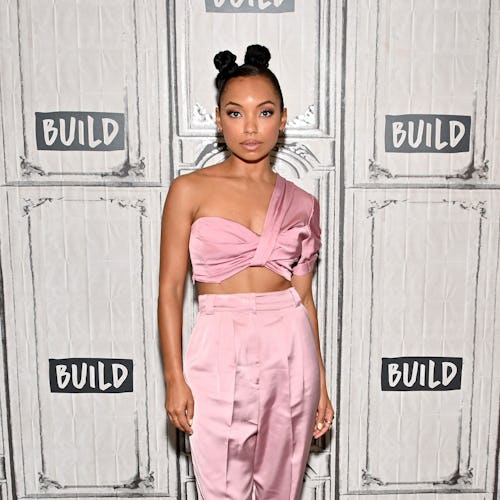 Logan Browning posing with her natural hairstyle with two buns