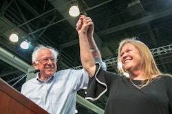 Bernie Sanders and his wife Jane Sanders holding their hands together and raising them