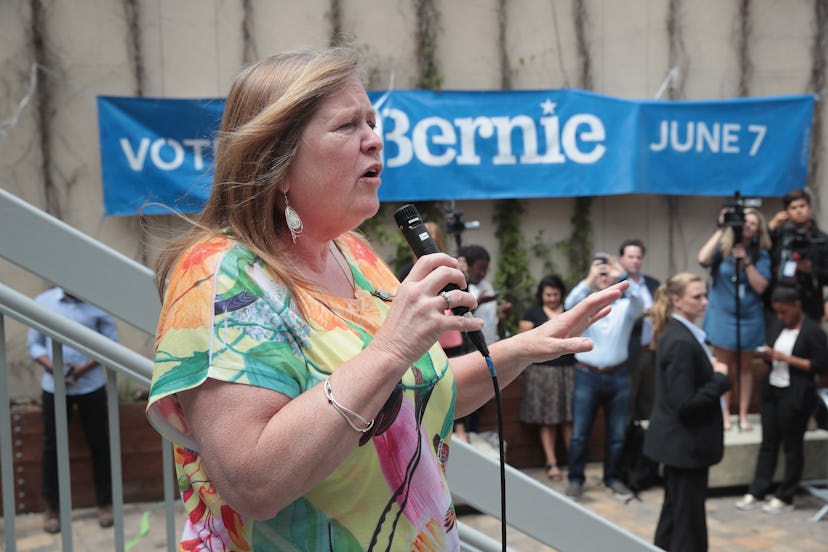 Jane Sanders speaking into a microphone at a Bernie Sanders rally 