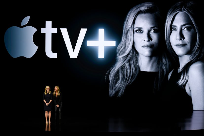 Reese Witherspoon and Jennifer Aniston next to an Apple TV plus logo