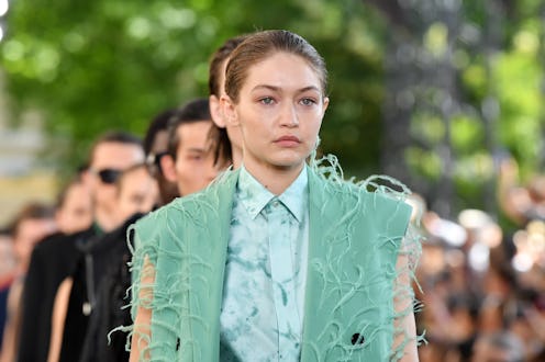 Gigi Hadid in a teal outfit at a fashion event