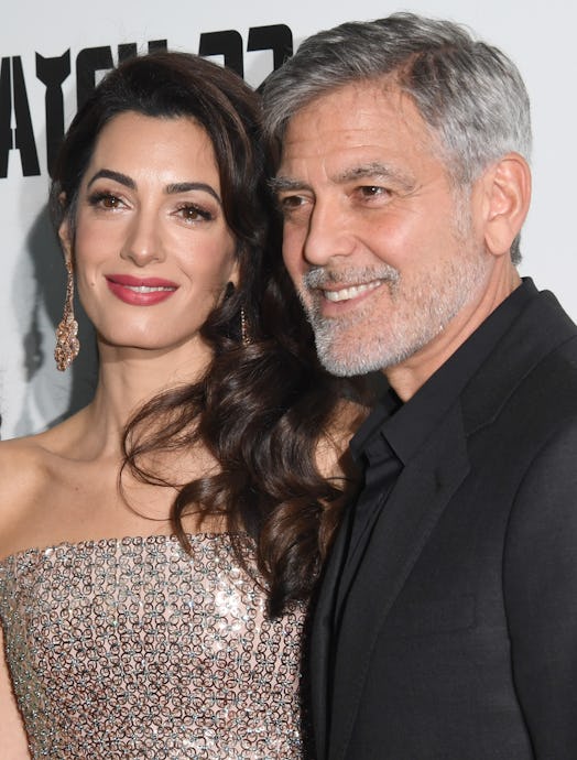 Amal wearing a berry pink shade of lipstick