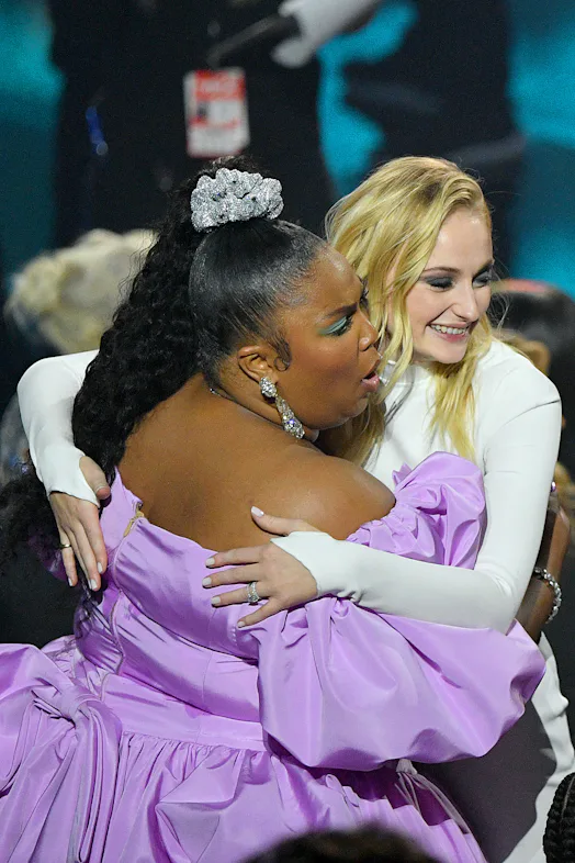 lizzo in purple dress Lizzo dazzles in completely sheer dress at Cardi B's party