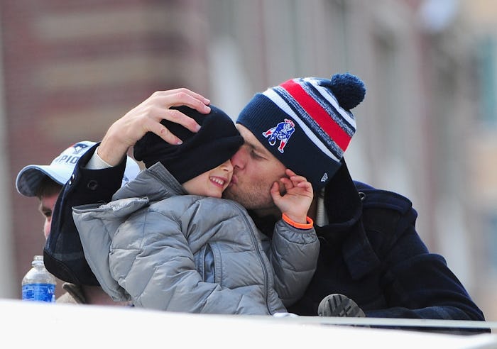 BOSTON, MA - FEBRUARY 04: Quarterback Tom Brady of the New England Patriots kisses his son Benjamin...