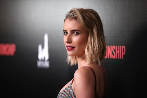 Emma Roberts with short blonde hair posing at a red carpet
