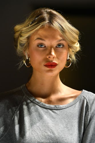 A woman with blonde hair and red lipstick looking directly into the camera
