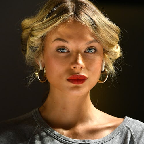 A woman with blonde hair and red lipstick looking directly into the camera