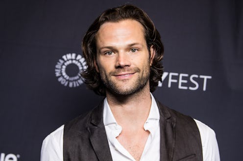Jared Padalecki on the red carpet wearing an unbuttoned white dress shirt and a black vest