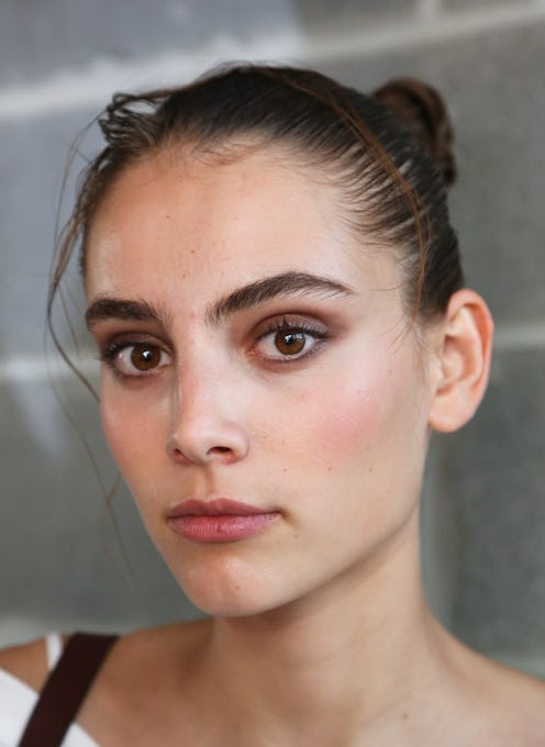 A model with healthy glowing skin after using the best face serums for fall.