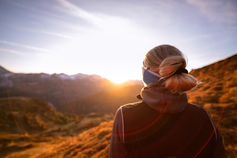 A woman looks at the sunset. Early menopause can occur in as many as one percent of all women, accor...