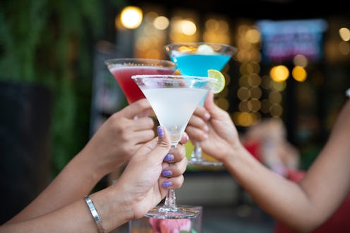 Three women toast martinis. Alcohol-related deaths are on the rise for women and other minority gend...