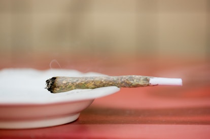 A joint sitting on the edge of an ash tray