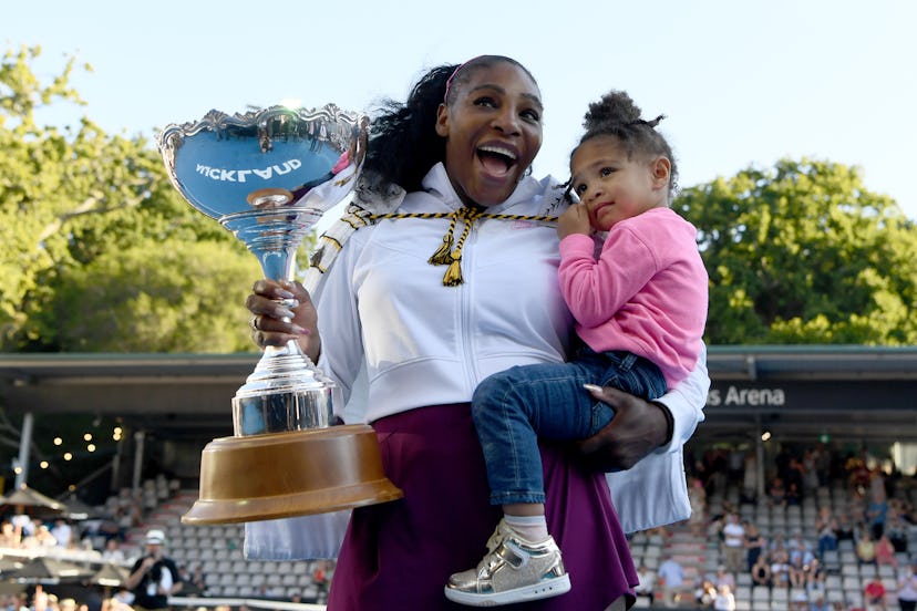 Serena Williams celebrates winning her first title since giving birth with daughter Olympia.