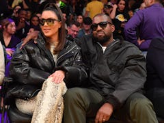 Kim Kardashian and Kanye West attend a Lakers game.