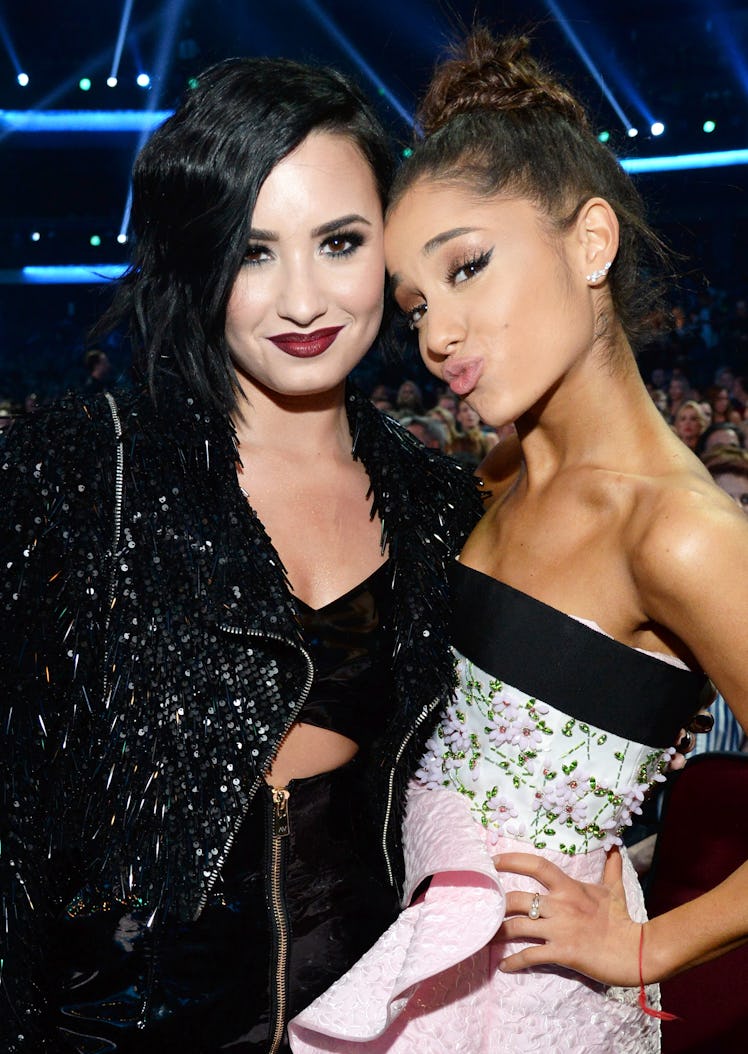 Ariana Grande and Demi Lovato attend an awards show.