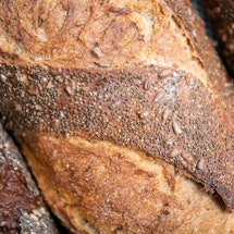 A closeup of three loaves of sourdough bread
