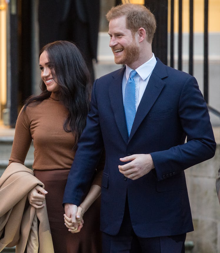 Meghan Markle and Prince Harry step out hand in hand.