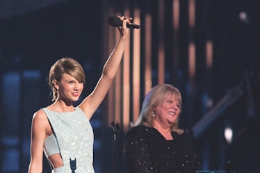 Taylor Swift stands on-stage with her mom, Andrea Swift.