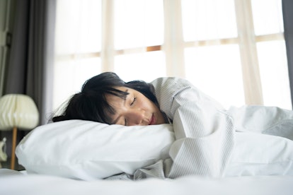 A woman sleeps. Adjusting your bedtime to fit your chronotype might help your sleep patterns. 