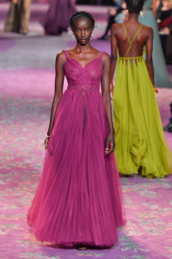 Anok Yai walking in a purple couture gown
