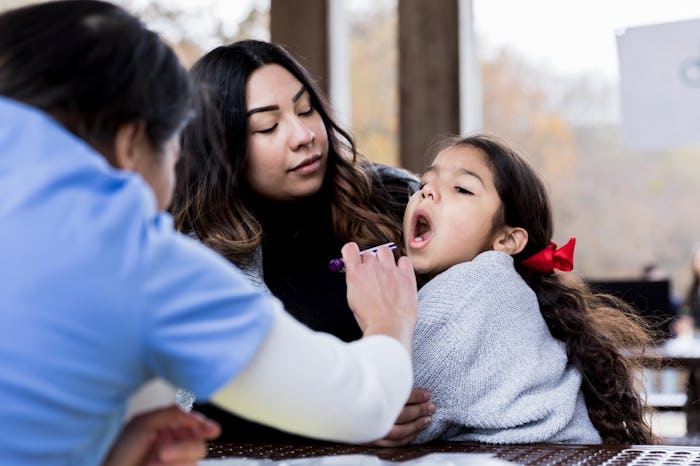 a little girl getting tested for flu