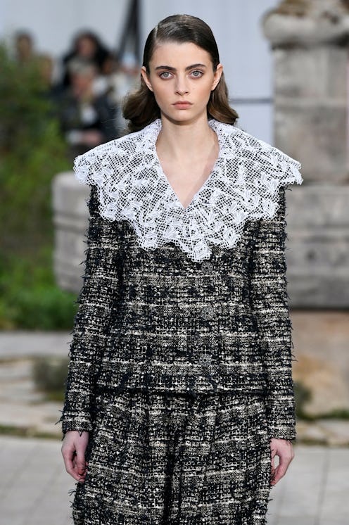 A model in a tweed suit with a white lace collar as a Spring 2020 trend from the couture runways