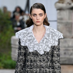 A model in a tweed suit with a white lace collar as a Spring 2020 trend from the couture runways