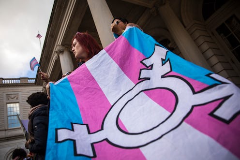 A transgender flag being carried by an activist. Bills denying healthcare to trans youth are based o...