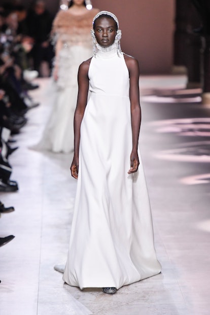 A model in a long white sleeveless dress as a Spring 2020 trend from the couture runways