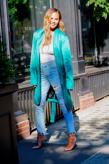 Chrissy Teigen wearing high-waisted jeans