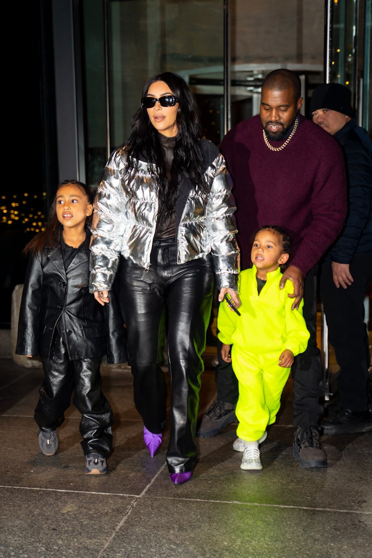 Kim Kardashian, Kanye West, North West, and Saint West step out together.