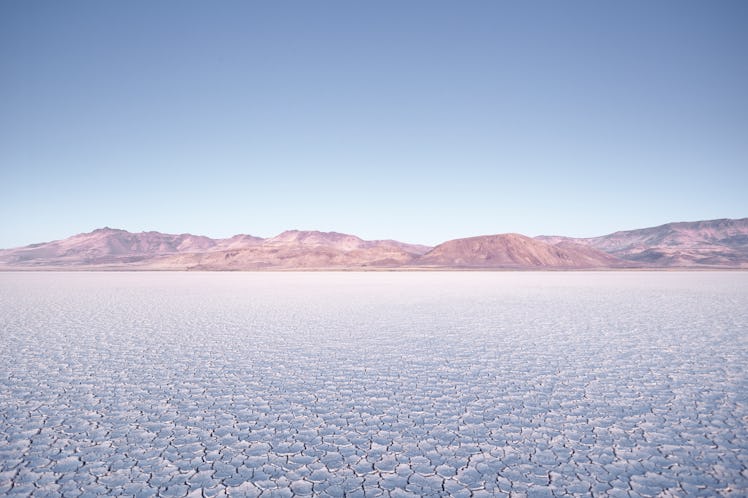 The Alvord Desert in Oregon features a cracked ground and faded mountains, and is perfect for an eng...