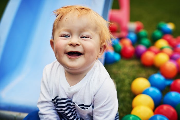 a red-haired baby boy outside