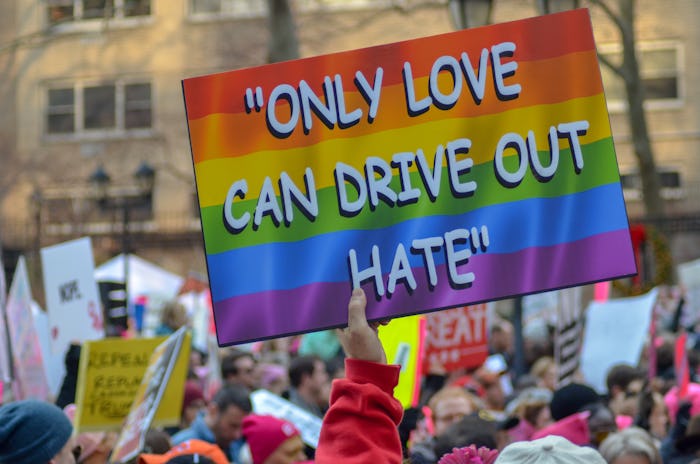 a woman holding up a sign at a women's march 