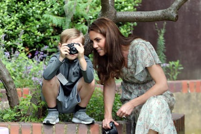 Middleton takes photos with children during workshop