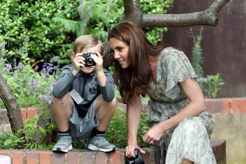 Middleton takes photos with children during workshop