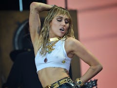 Miley Cyrus rocks out on stage. 