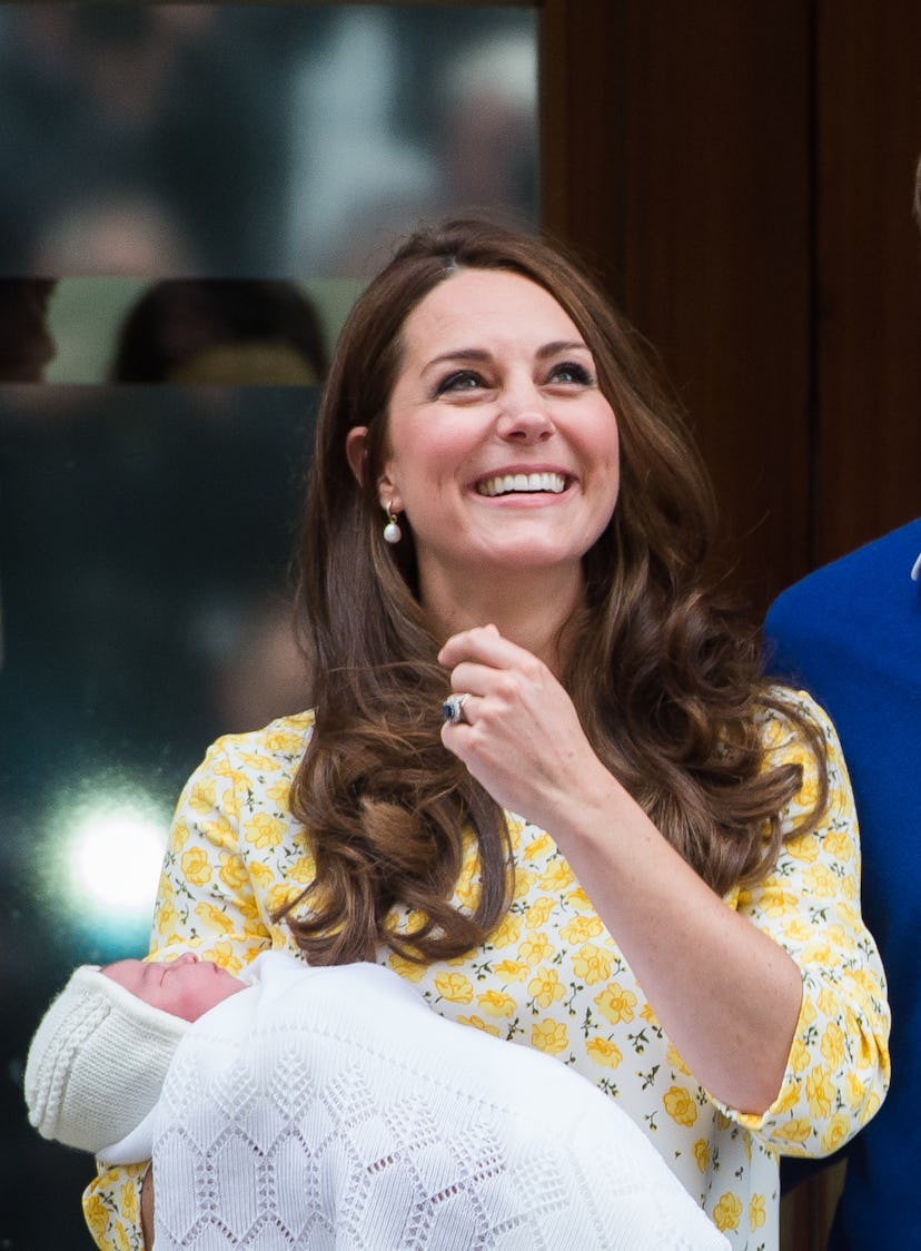 Middleton holds Princess Charlotte for her first public appearance