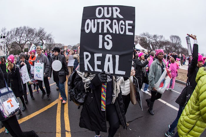 people at a women's march holding signs
