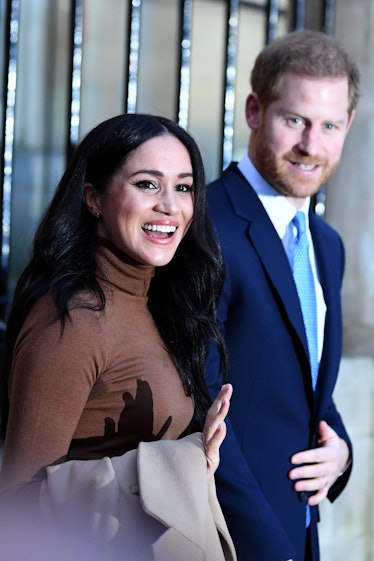 Meghan Markle and Prince Harry wave to fans.