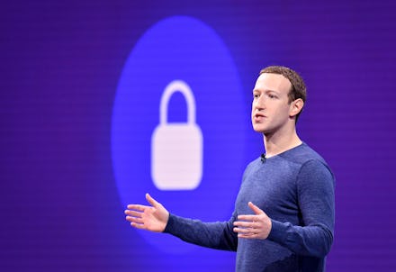 Mark Zuckerberg with his arms open delivering a speach in front of a logo of a lock