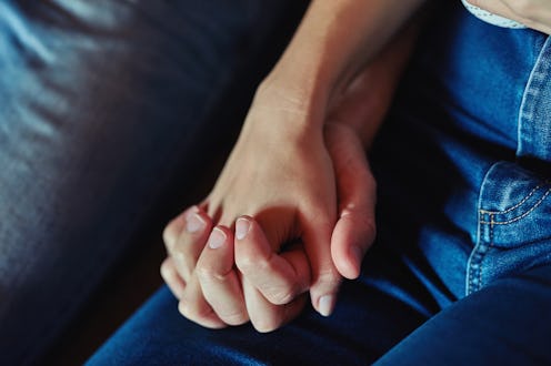A woman holds her partner's hand following a pregnancy loss. Women explain what their miscarriages w...