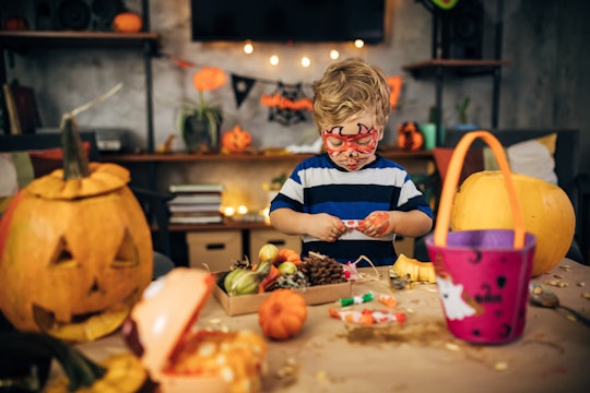 little boy unwrapping halloween candy