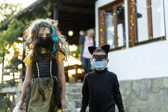 kids going trick or treating in face masks