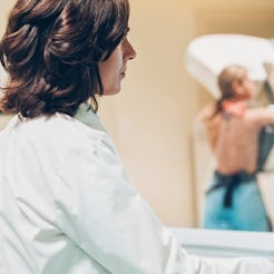 A doctor looks at a mammogram. Some breast cancers, like triple negative breast cancers, develop muc...