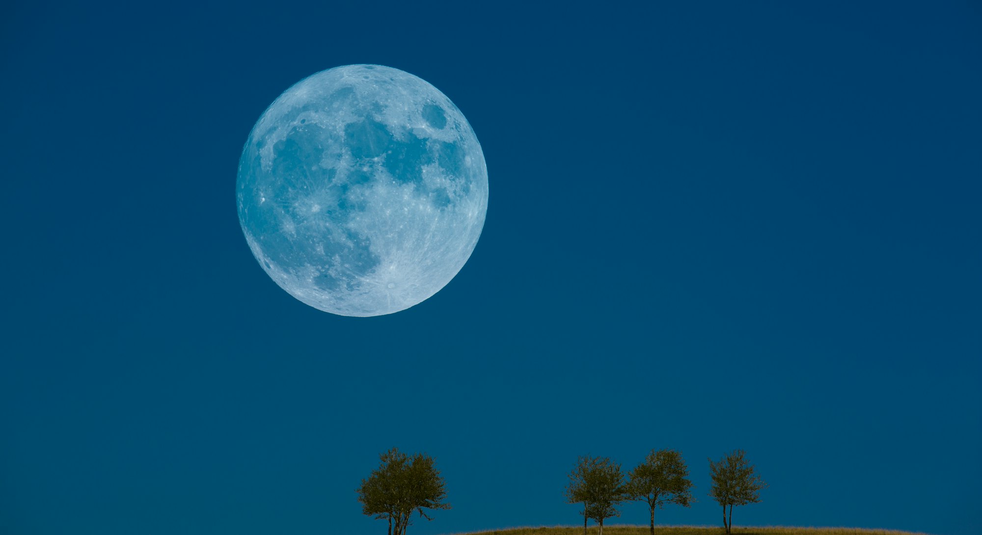 Rare blue full moon on blue sky